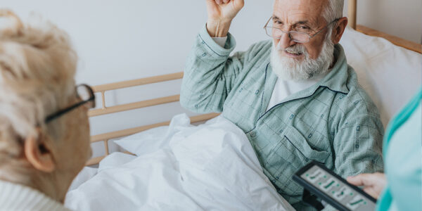 senior-patient-gets-up-from-the-hospital-bed-by-he-2022-02-02-04-48-54-utc